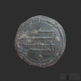 Round, weathered ancient coin with worn Arabic-style inscriptions around the edge and a dark patina; central design is indistinct due to wear.